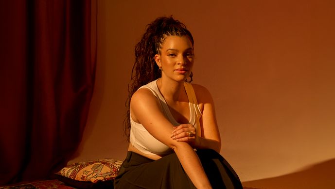 Elena Pingerhughes sitting in warm lighting