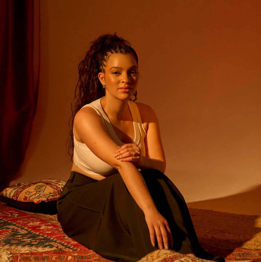 Elena Pingerhughes sitting in warm lighting