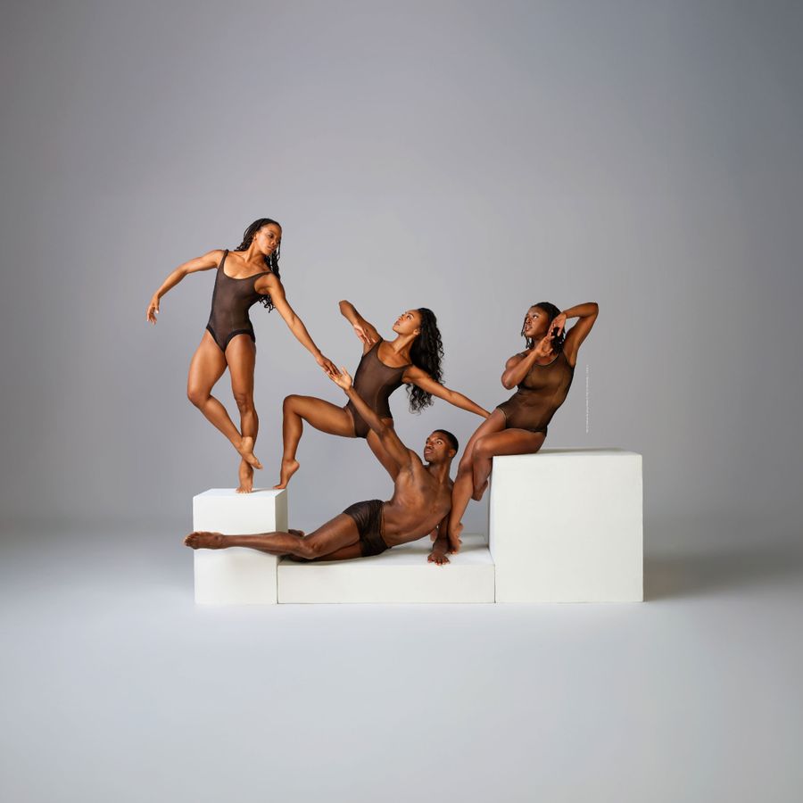 Modern Dance Company Performing in Dramatic Lighting