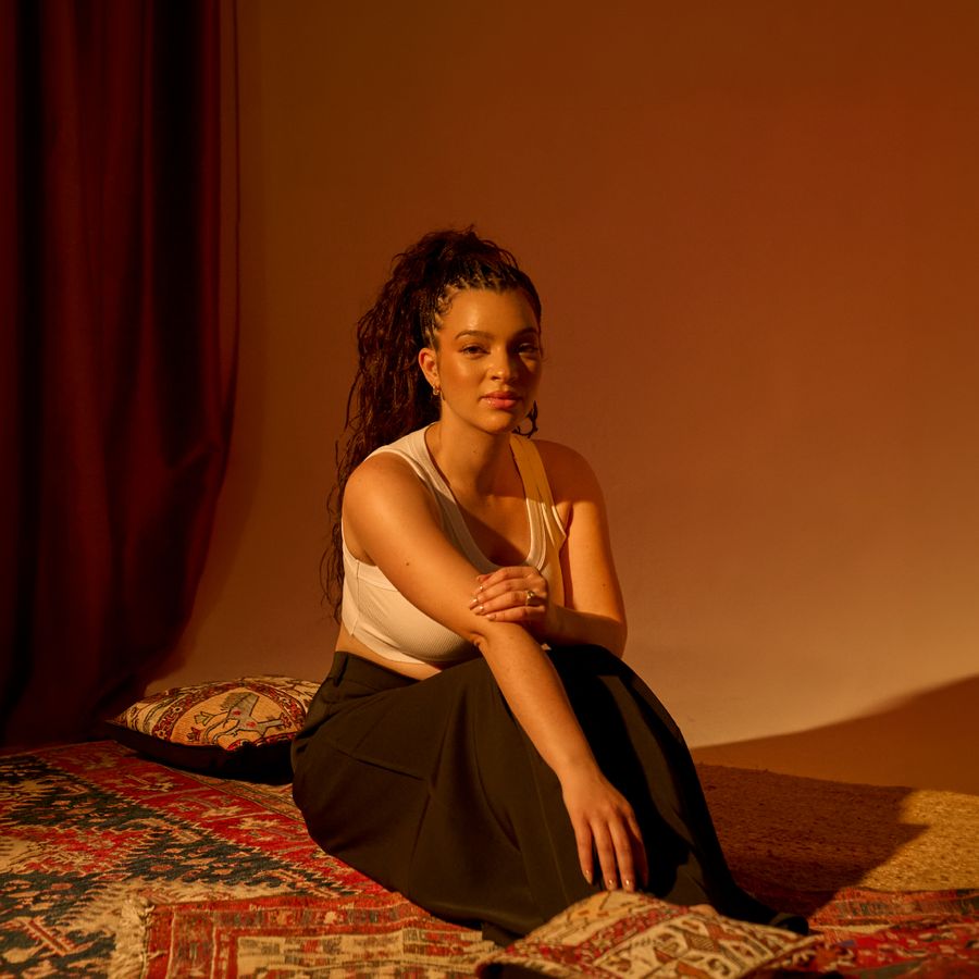 Elena Pingerhughes sitting in warm lighting