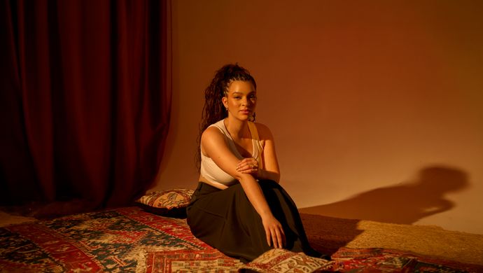 Elena Pingerhughes sitting in warm lighting